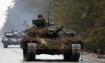 Tanks driving down a road.